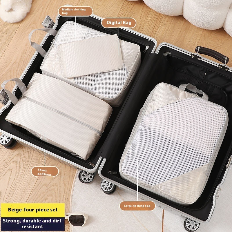 Packing cubes labeled with sizes and types being used to pack a suitcase.