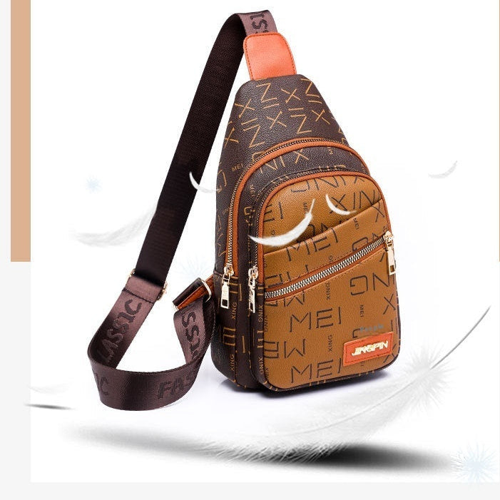 Brown leather sling bag with decorative patterns on a white background