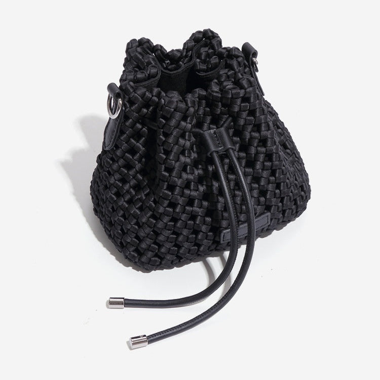 Black woven bucket bag on a white background