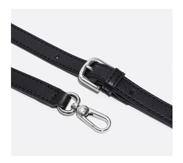 Black leather shoulder strap with silver hardware on a white background