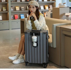 Woman sitting with a large suitcase in a modern interior setting