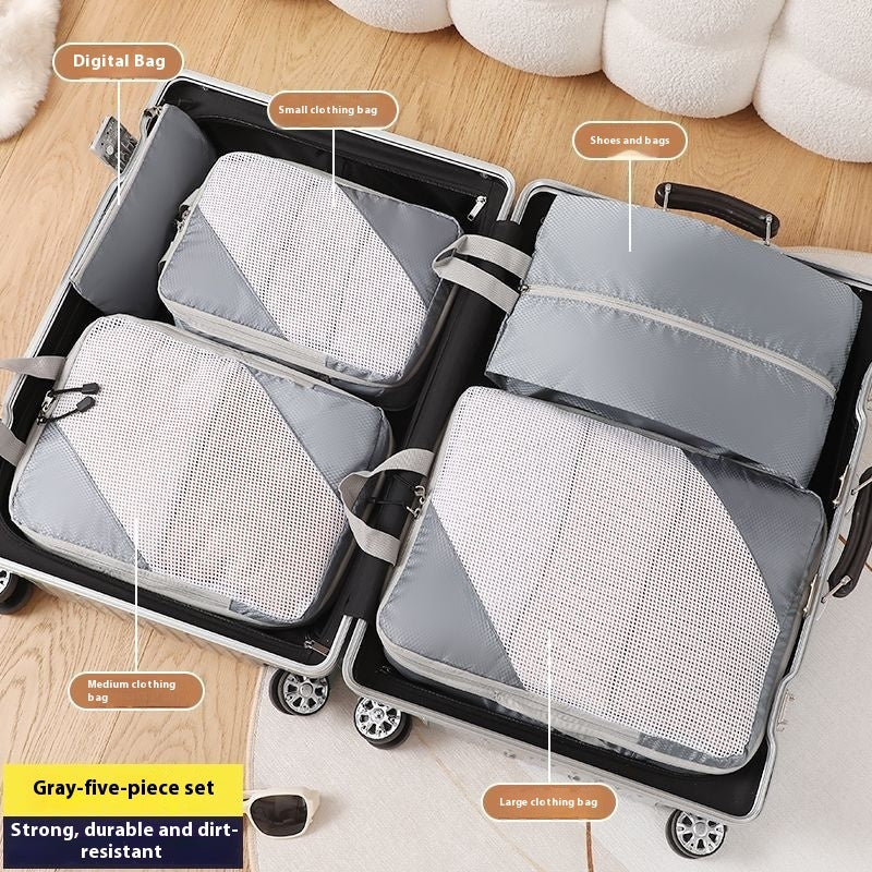 Set of gray packing cubes labeled with sizes and functions, placed inside an open suitcase.